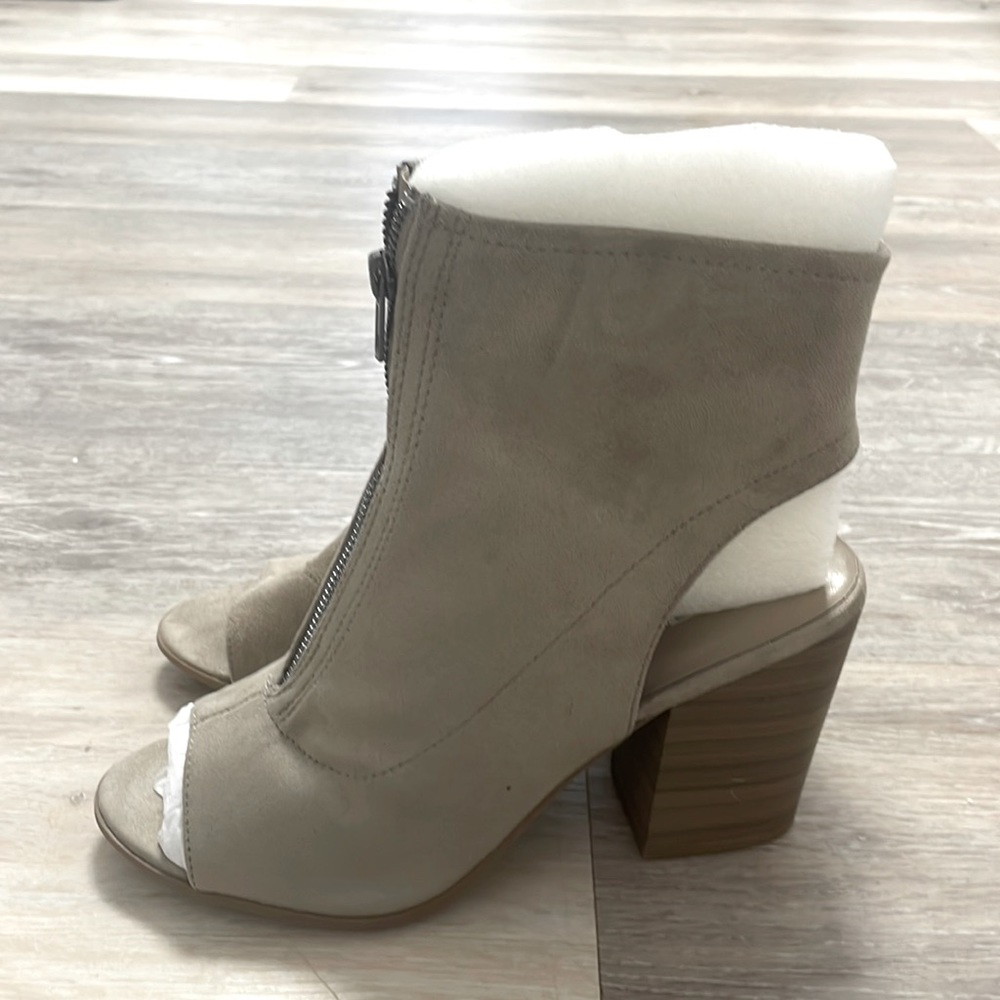 Grey heels that zip up. Never worn before